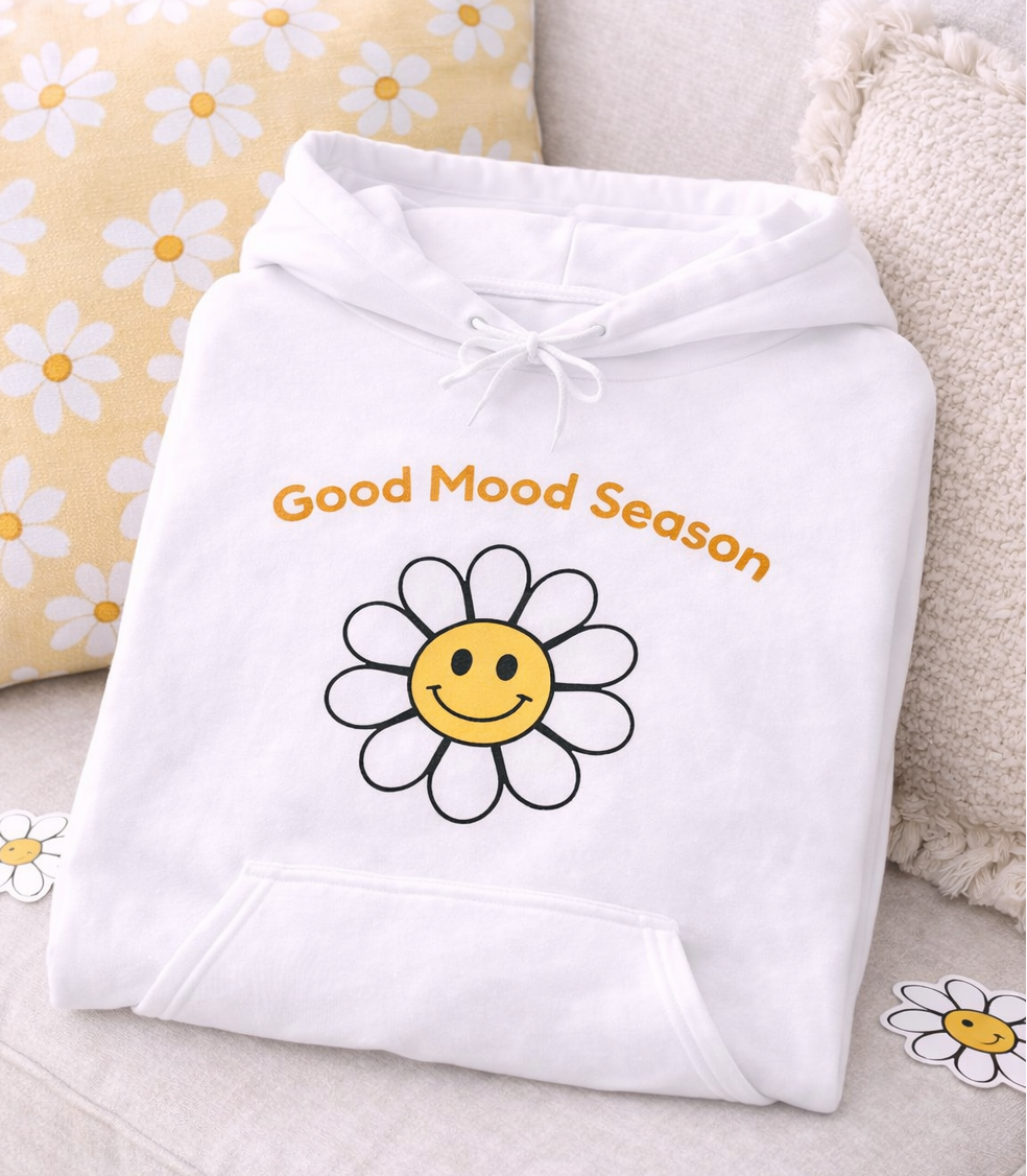 Weißer Unisex-Hoodie mit gelbem Smiley-Blumenmotiv und dem Schriftzug „Good Mood Season“ auf der Vorderseite.