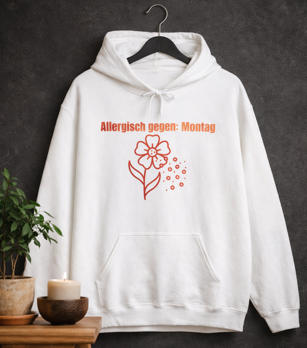 Weißer Unisex-Hoodie mit dem Spruch „Allergisch gegen Montag“ und humorvollem Blumenmotiv mit fliegenden Pollen auf der Vorderseite.