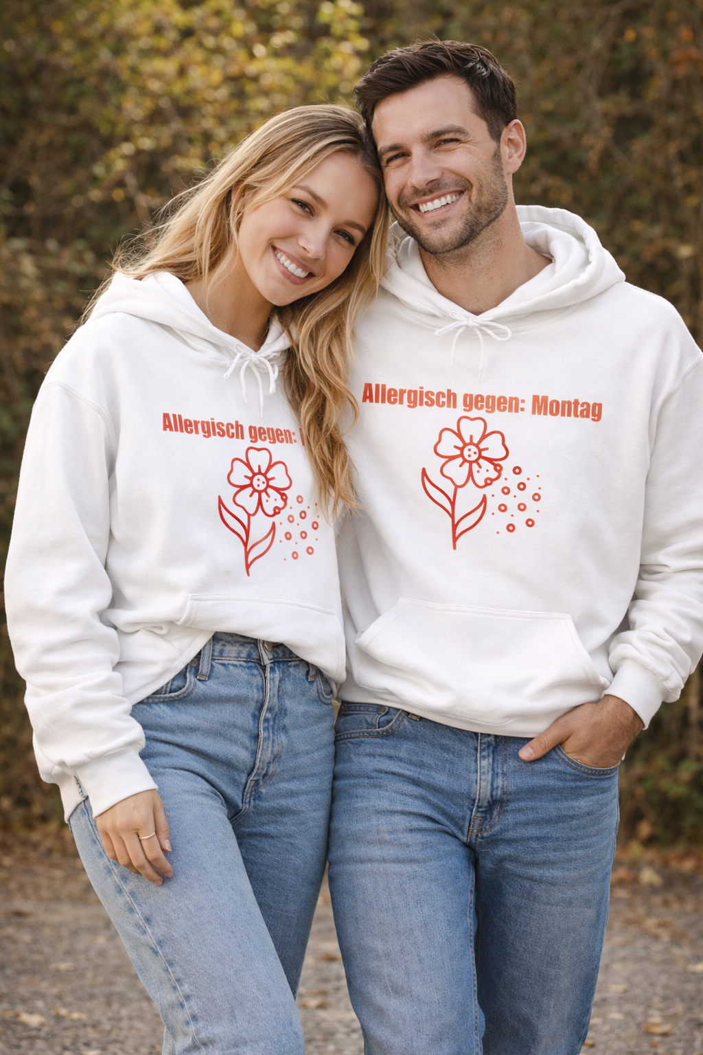 Weißer Unisex-Hoodie mit dem Spruch „Allergisch gegen Montag“ und humorvollem Blumenmotiv mit fliegenden Pollen auf der Vorderseite.