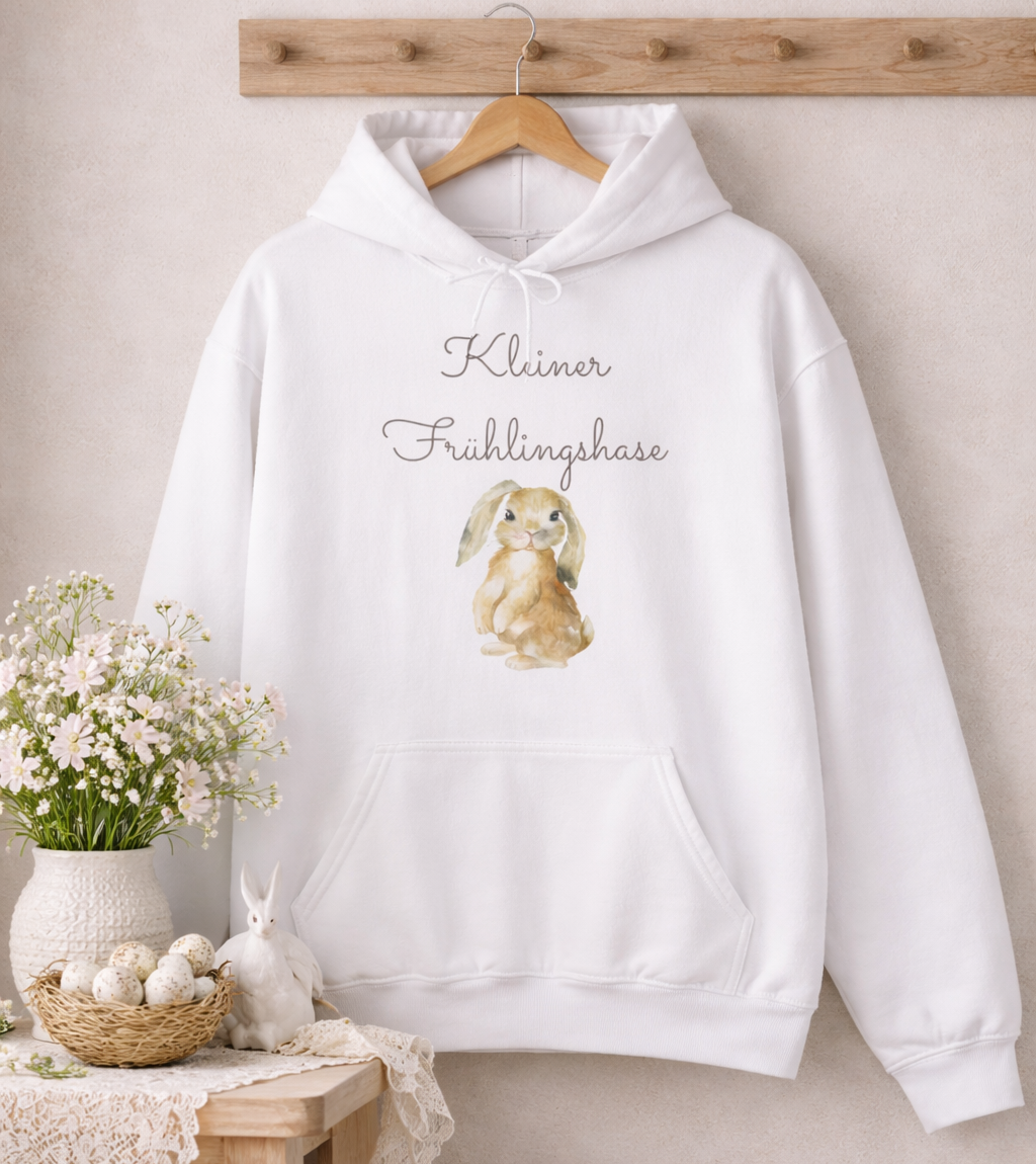 Weißer Unisex-Hoodie mit süßem Hasenmotiv und dem Schriftzug „Kleiner Frühlingshase“ auf der Vorderseite.