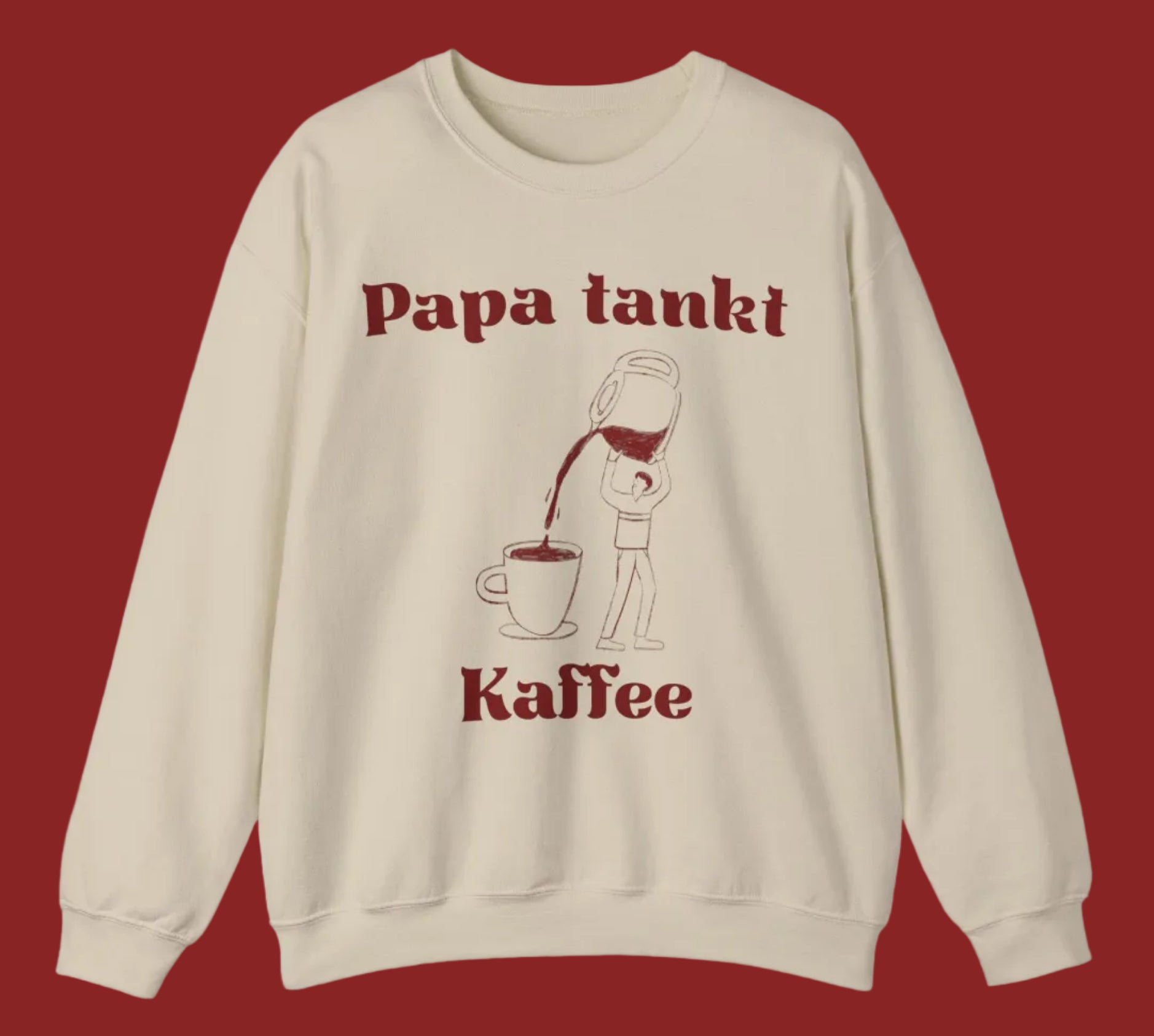 Weißes und sandfarbenes Unisex-Sweatshirt mit dem Aufdruck „Papa tankt Kaffee“ und einer humorvollen Illustration einer Person, die Kaffee aus einer großen Kanne in eine Tasse gießt.