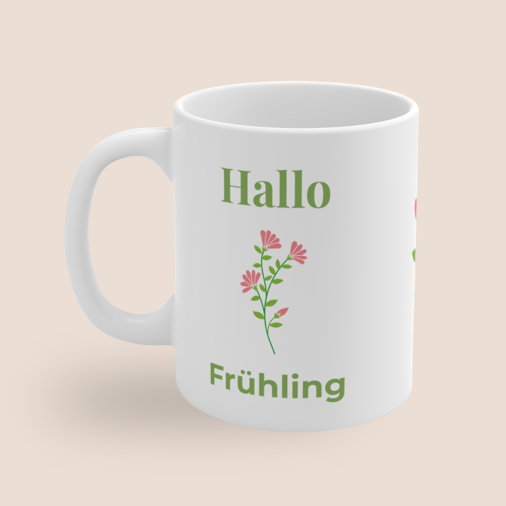 Weiße Keramiktasse mit dem Schriftzug „Hallo Frühling“ und einem zarten rosa Blumenmotiv – frühlingshafte 300-ml-Tasse für Kaffee oder Tee.
